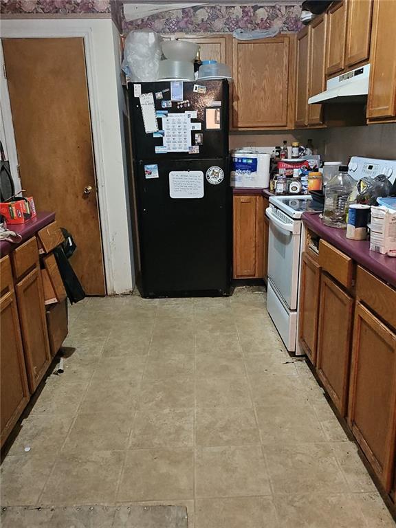 207 Fowler Street Swainsboro, GA 30401 - Photo 8 of 9 a kitchen with refrigerator and cabinets