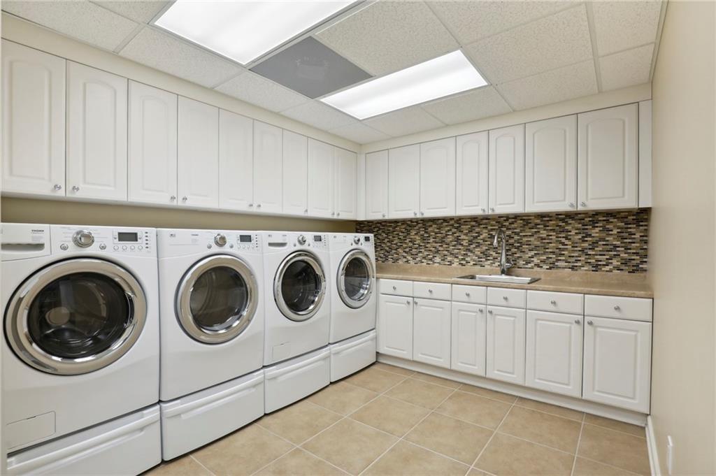 1965 West Wesley Road Northwest Atlanta, GA 30327 - Photo 25 of 34 a utility room with sink dryer and washer