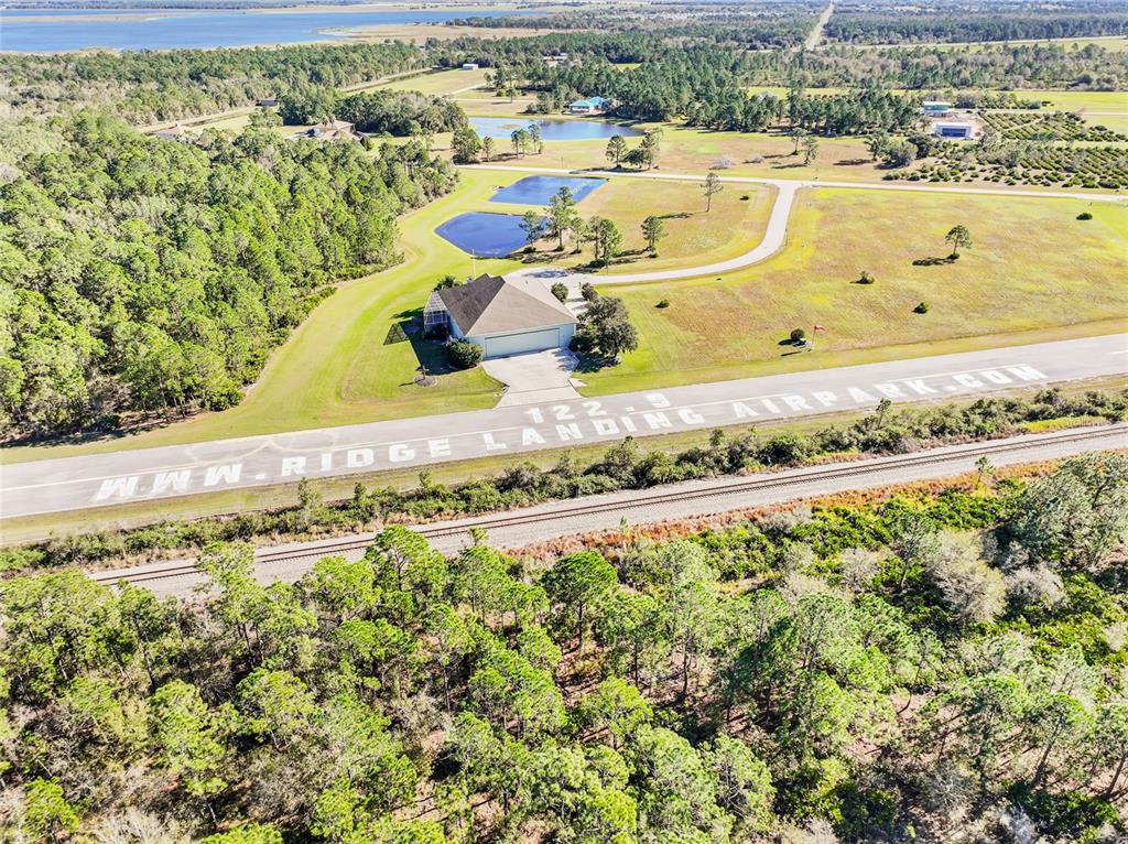 4540 Lindbergh Drive Frostproof, FL 33843 - Photo 13 of 14 a view of a swimming pool with a garden