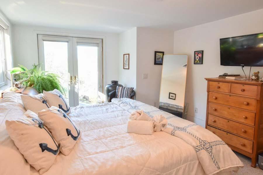 16 Thistlemore Road Provincetown, MA 02657 - Photo 15 of 27 a bedroom with a bed and a flat screen tv