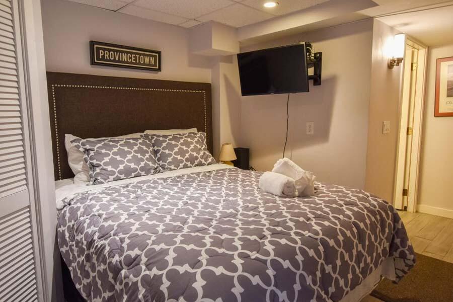 16 Thistlemore Road Provincetown, MA 02657 - Photo 16 of 27 a bedroom with a large bed and a flat screen tv