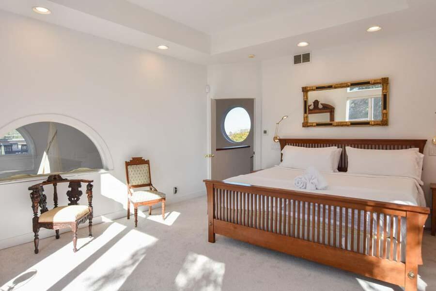 16 Thistlemore Road Provincetown, MA 02657 - Photo 24 of 27 a bedroom with a bed and a chandelier