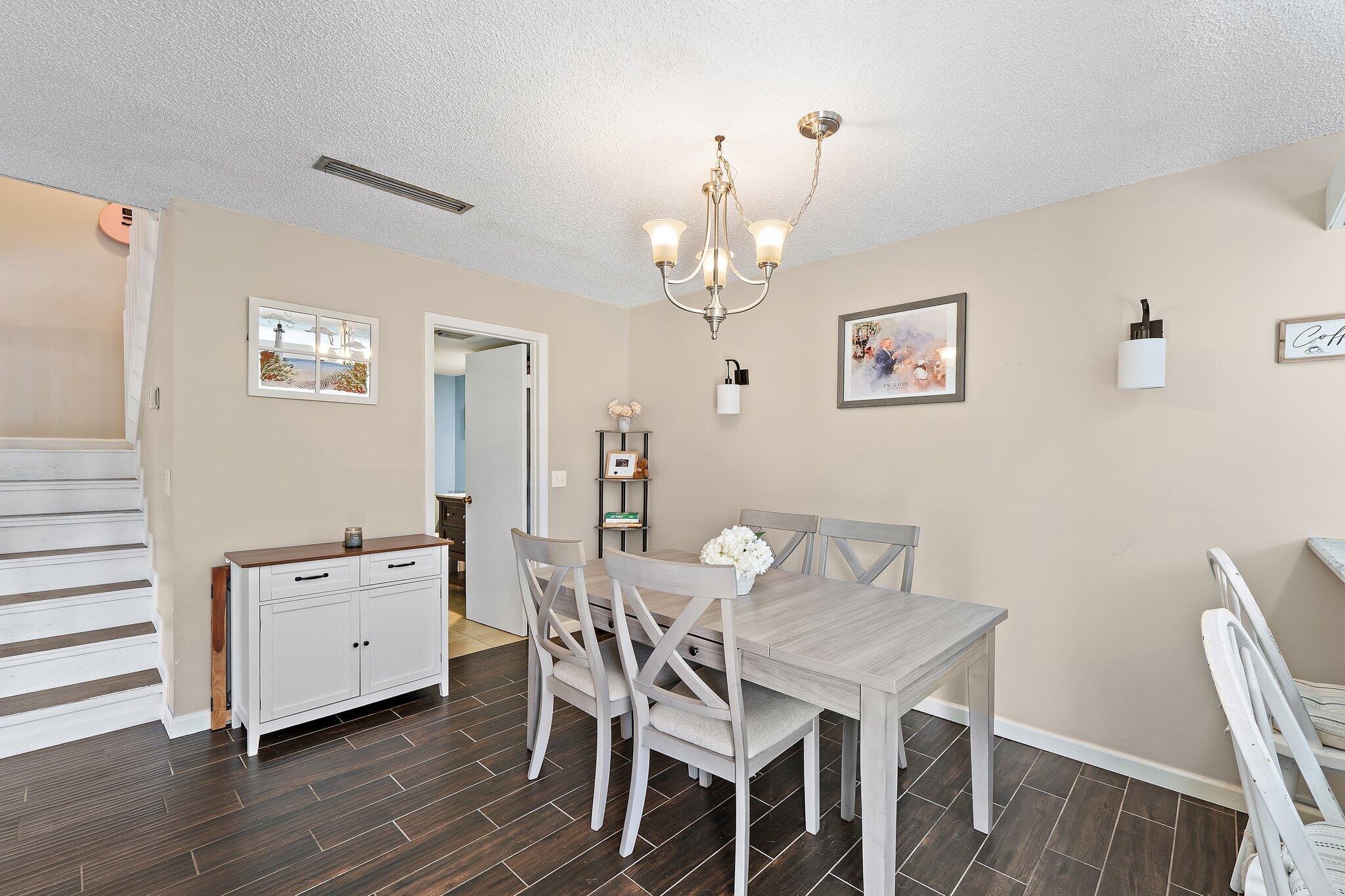 825 Center Street, Unit 30A Jupiter, FL 33458 - Photo 11 of 33 a view of a dining room with furniture and wooden floor