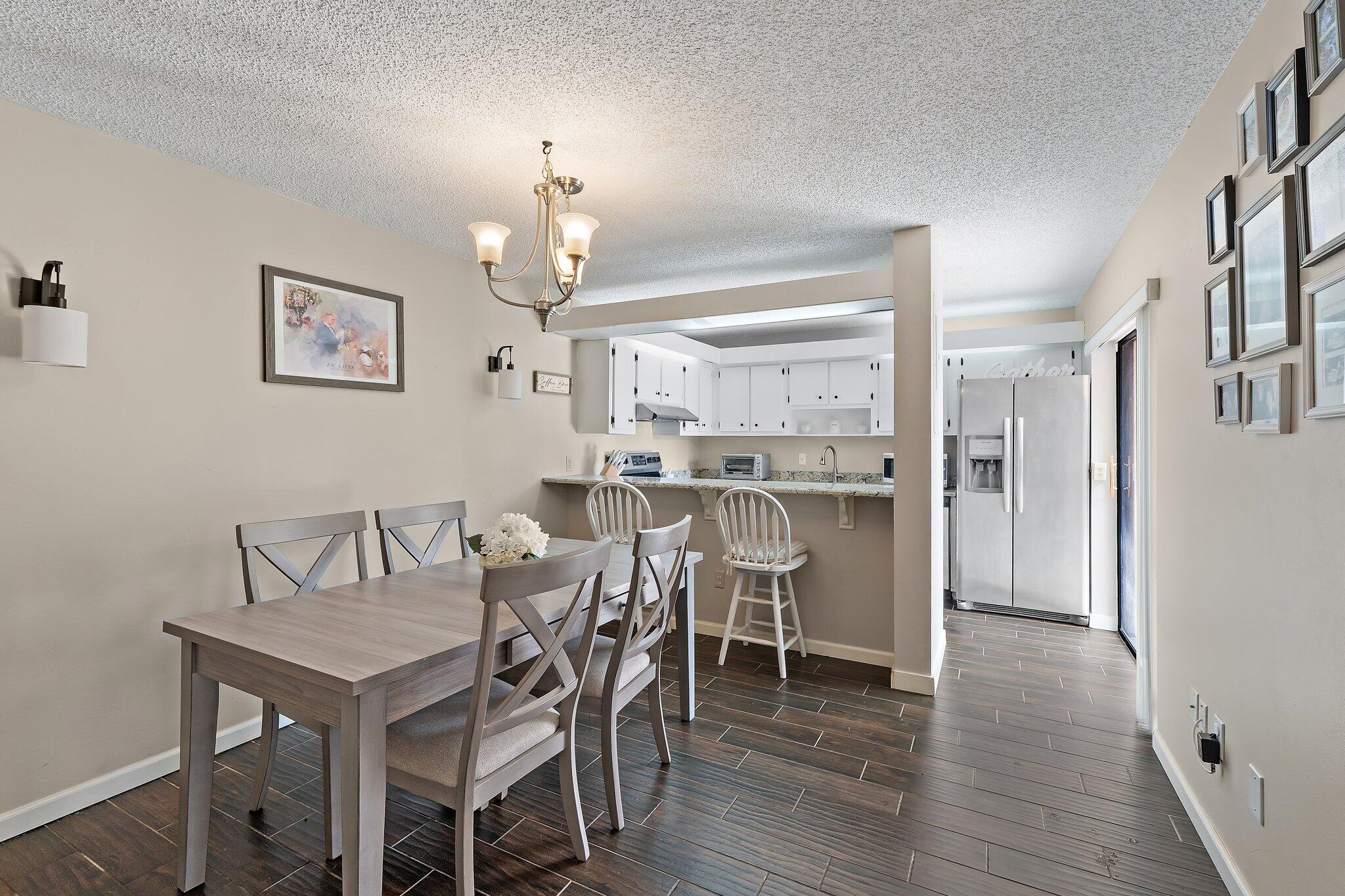 825 Center Street, Unit 30A Jupiter, FL 33458 - Photo 12 of 33 a view of a dining room with furniture and wooden floor