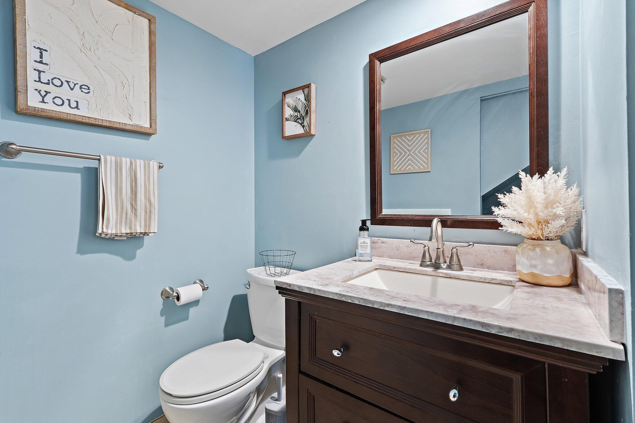 825 Center Street, Unit 30A Jupiter, FL 33458 - Photo 16 of 33 a bathroom with a granite countertop toilet sink and mirror