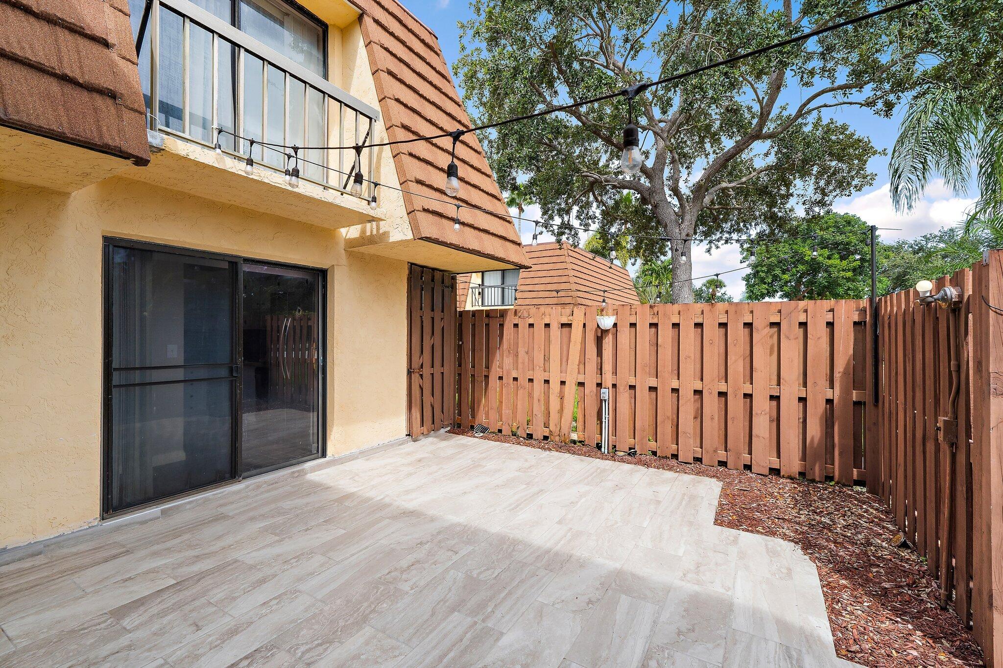 825 Center Street, Unit 30A Jupiter, FL 33458 - Photo 5 of 33 a view of a house with a wooden fence
