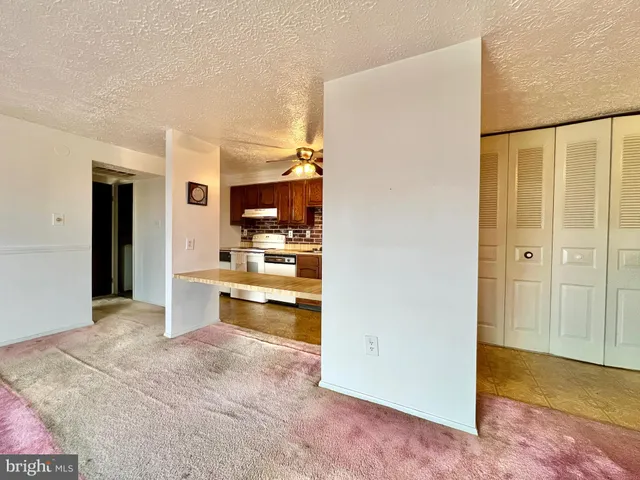 a view of a kitchen with a refrigerator and a sink