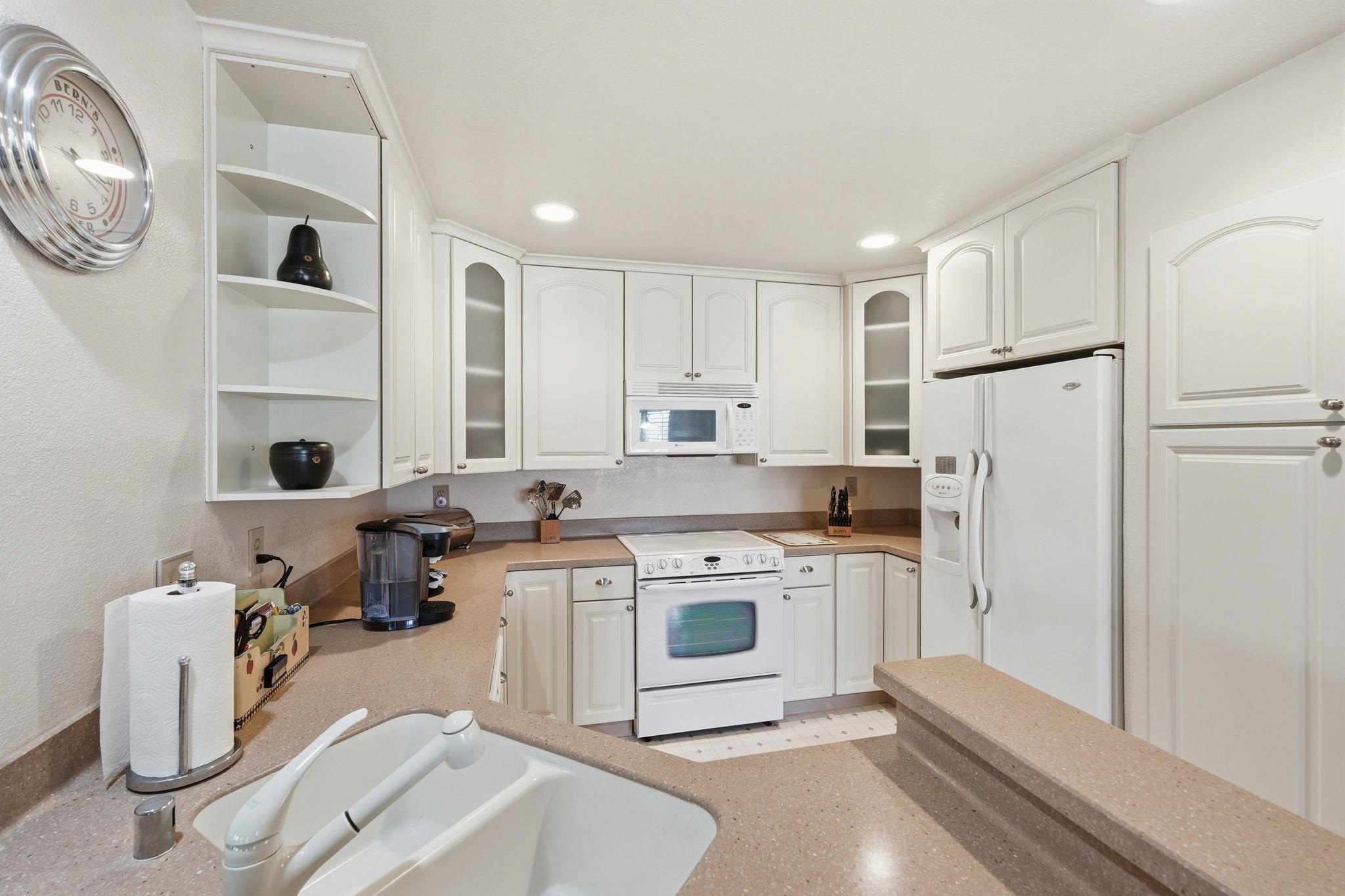 1643 West Swain Road Stockton, CA 95207 - Photo 12 of 27 a kitchen with a stove and a refrigerator