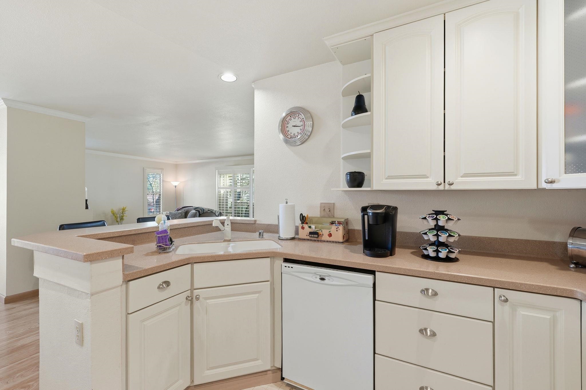 1643 West Swain Road Stockton, CA 95207 - Photo 13 of 27 a kitchen with cabinets and white stainless steel appliances