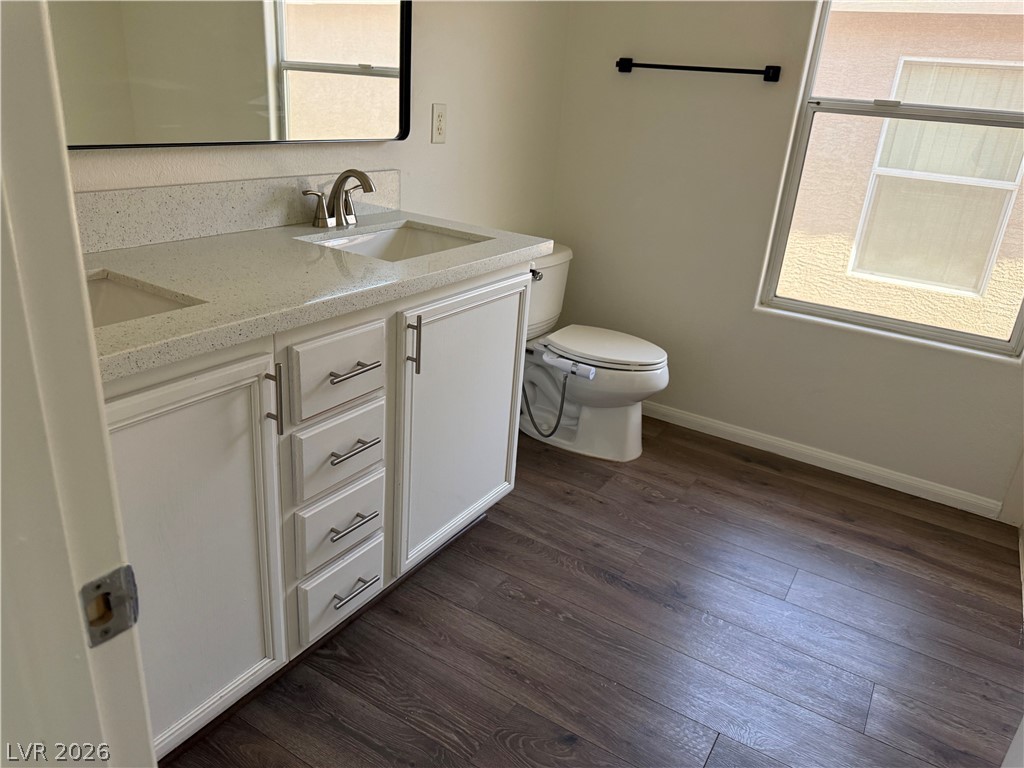 1141 Cathedral Ridge Street Henderson, NV 89052 - Photo 51 of 77 This bathroom features a double vanity and a bright window, offering both functionality and natural light.