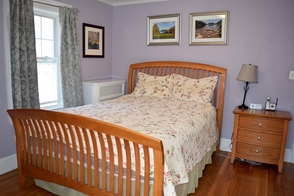24 Norwell Road Dedham, MA 02026 - Photo 16 of 21 a bed sitting in a bedroom next to a window