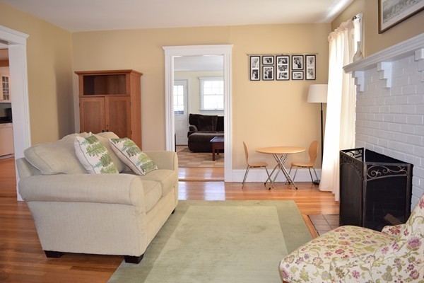 24 Norwell Road Dedham, MA 02026 - Photo 3 of 21 a living room with furniture and a fireplace