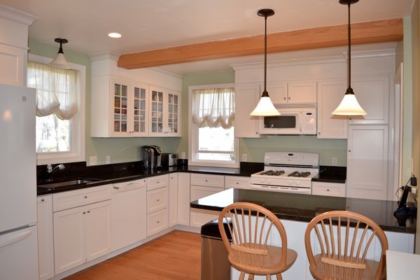 24 Norwell Road Dedham, MA 02026 - Photo 6 of 21 a kitchen with stainless steel appliances a stove a sink a window and chairs