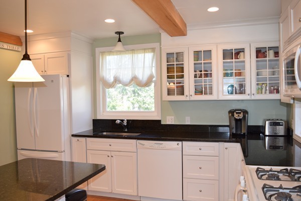 24 Norwell Road Dedham, MA 02026 - Photo 7 of 21 a kitchen with a refrigerator a stove and a sink with wooden floor