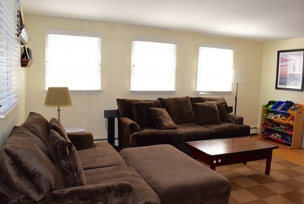 24 Norwell Road Dedham, MA 02026 - Photo 8 of 21 a living room with furniture a large window and a lamp
