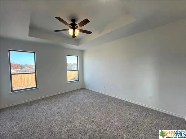 a view of a livingroom with a ceiling fan and window