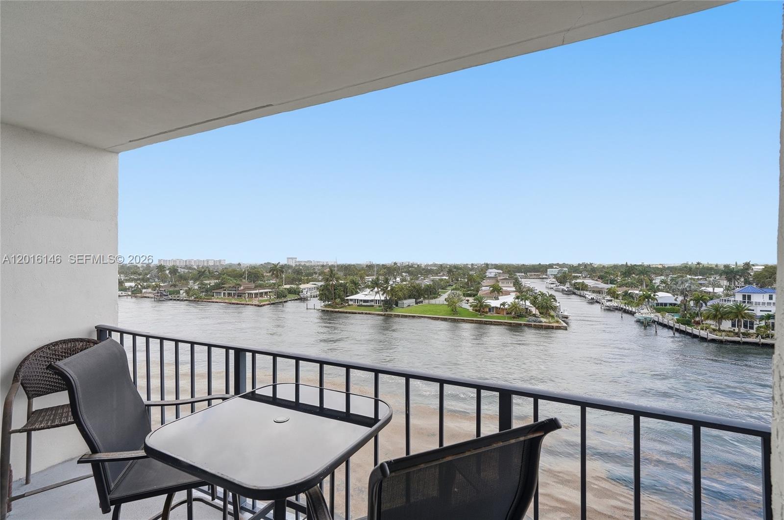 521 North Riverside Drive, Unit 606 Pompano Beach, FL 33062 - Photo 13 of 50 a view of a balcony with wooden floor and outdoor seating