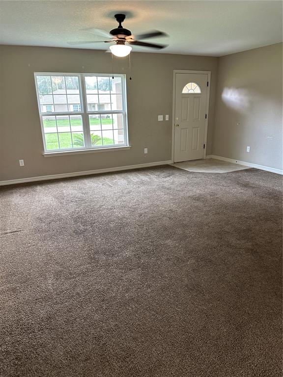 5663 Northwest 57th Street Ocala, FL 34482 - Photo 2 of 19 an empty room with a empty space and windows