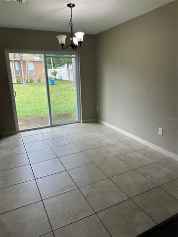 a kitchen with granite countertop a refrigerator and a stove top oven