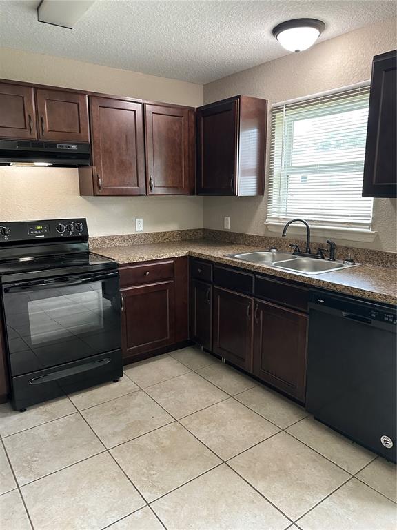 5663 Northwest 57th Street Ocala, FL 34482 - Photo 7 of 19 a kitchen with a sink stove top oven and cabinets