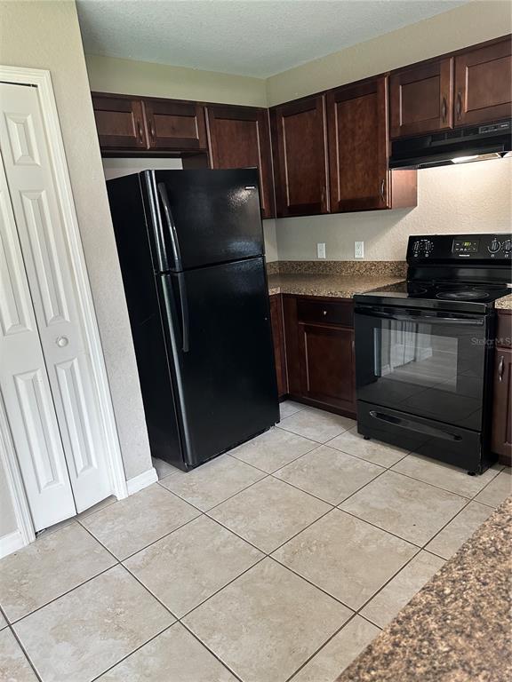 5663 Northwest 57th Street Ocala, FL 34482 - Photo 8 of 19 a kitchen with granite countertop a refrigerator and a sink