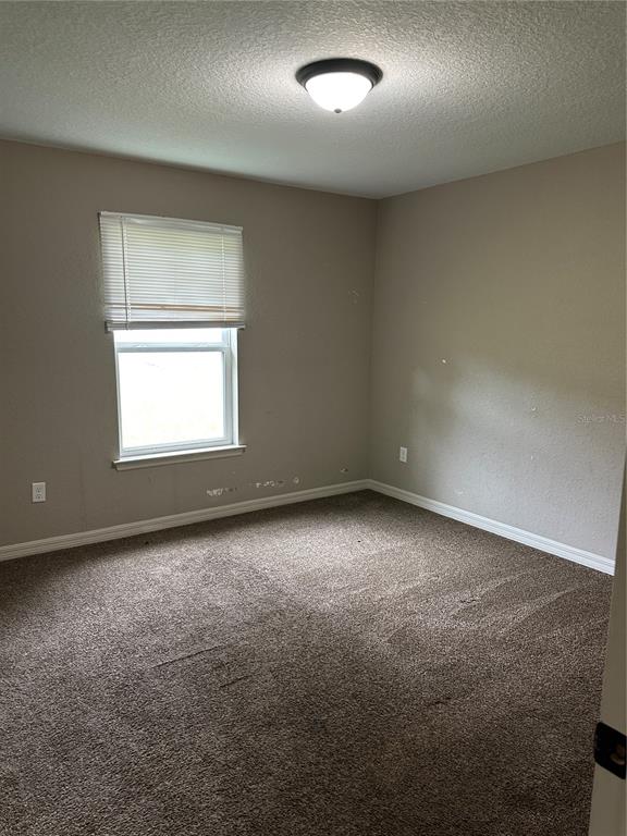 5663 Northwest 57th Street Ocala, FL 34482 - Photo 9 of 19 an empty room with a window