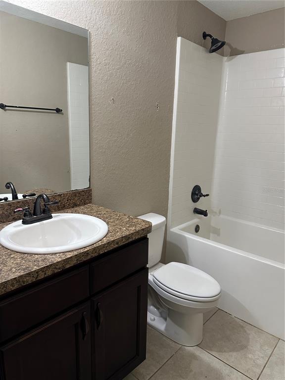 5663 Northwest 57th Street Ocala, FL 34482 - Photo 10 of 19 a bathroom with a granite countertop sink toilet and shower