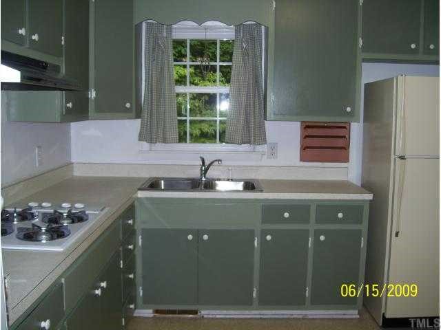 2608 Ramsey Road Raleigh, NC 27604 - Photo 10 of 12 a sink with a granite countertop lots of counter top space and stove top oven