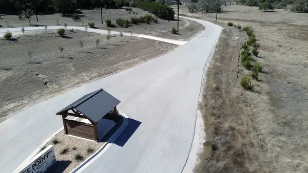 a view of a yard with a wooden fence