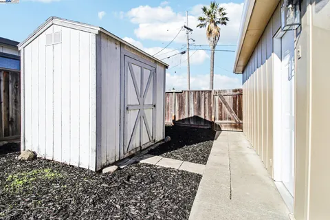 a very nice looking yard with wooden fence