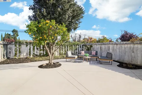 a view of a patio with table and chairs and potted plants
