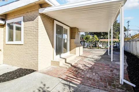 a view of a chairs and table in the patio