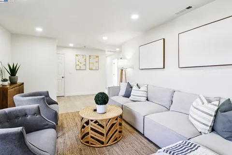 a living room with furniture and a potted plant