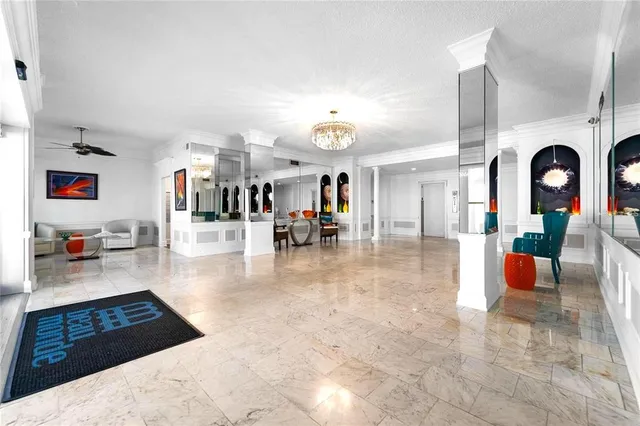 a spacious bedroom with a bed and a chandelier