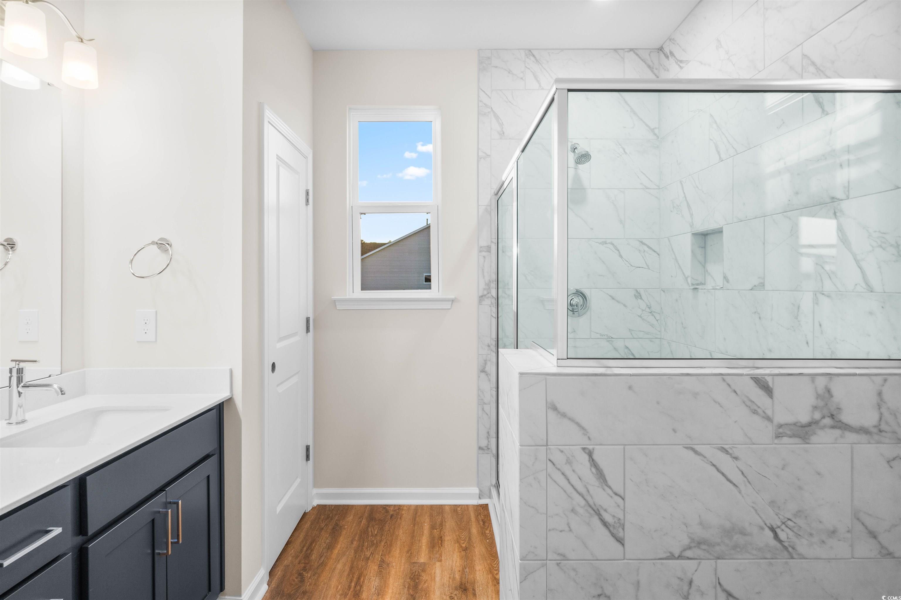 500 Sheepbridge Way Longs, SC 29568 - Photo 6 of 26 Bathroom featuring double vanity, a marble finish shower, linen closet, separate water closet, and dark wood finished floors