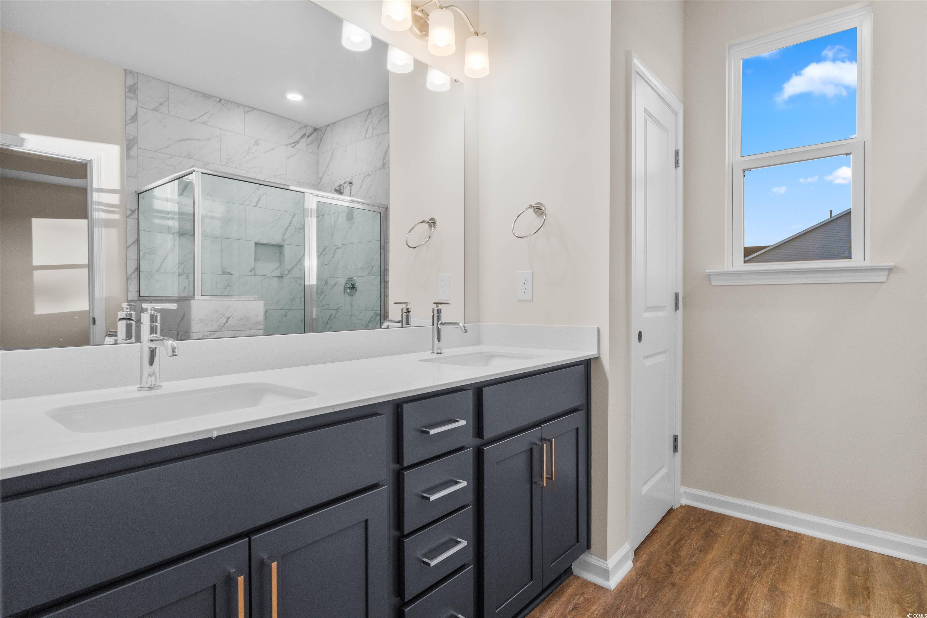 500 Sheepbridge Way Longs, SC 29568 - Photo 7 of 26 Bathroom featuring double vanity, a marble finish shower, linen closet, separate water closet, and dark wood finished floors