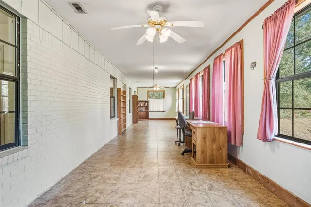 a view of a livingroom with furniture and a chandelier fan