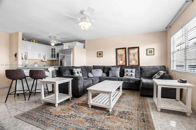 a living room with furniture a rug and a window