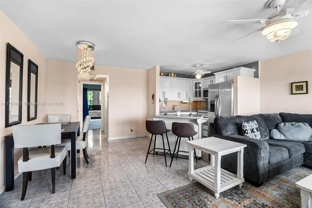 a living room with furniture and a dining table