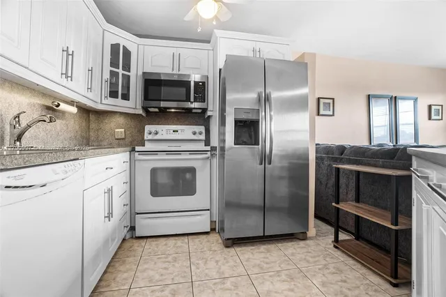 a kitchen with stainless steel appliances and cabinets