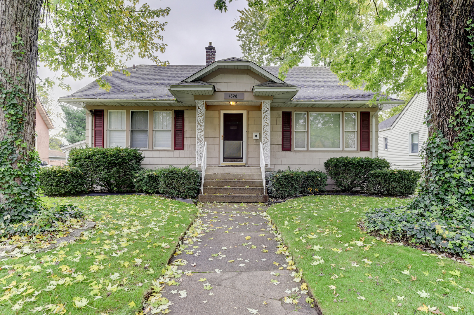 a front view of a house with yard and green space