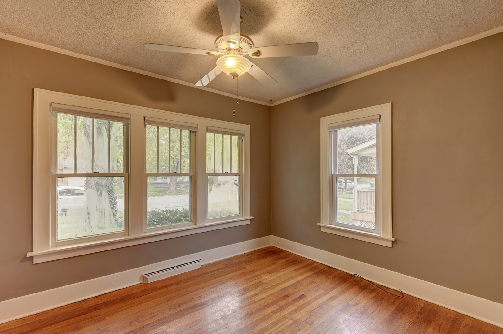 18281 Walter Street Lansing, IL 60438 - Photo 6 of 15 a view of an empty room with wooden floor and a window
