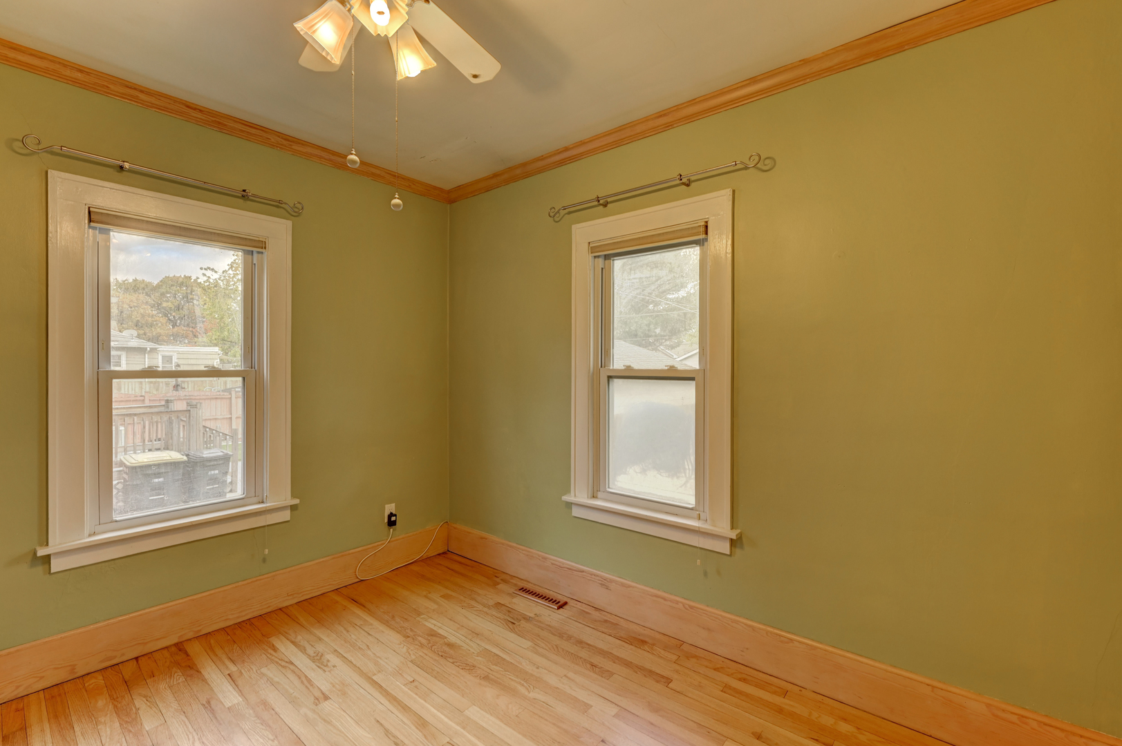18281 Walter Street Lansing, IL 60438 - Photo 7 of 15 a view of an empty room with wooden floor and a window