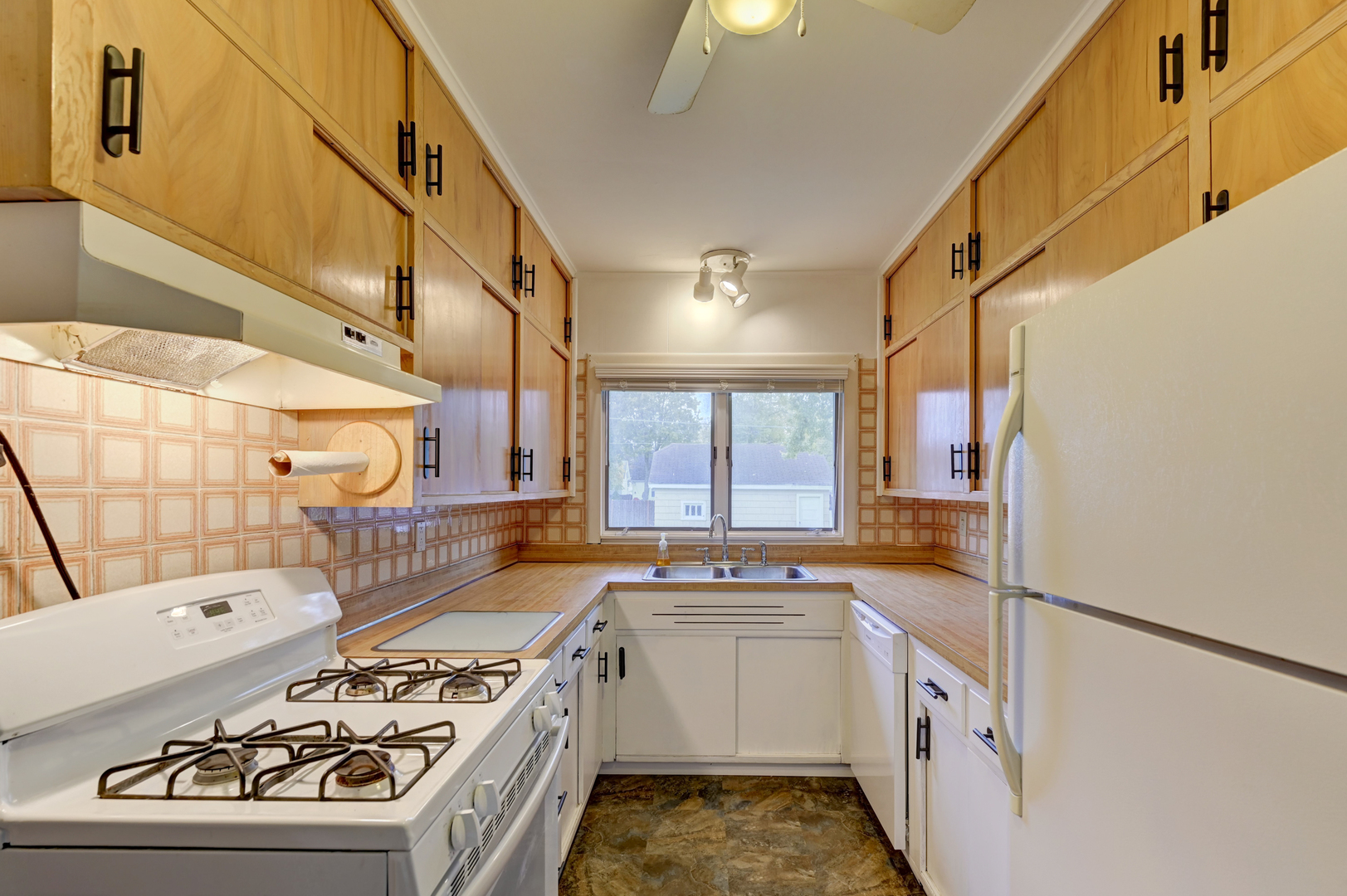 18281 Walter Street Lansing, IL 60438 - Photo 8 of 15 a kitchen with a sink stove and cabinets