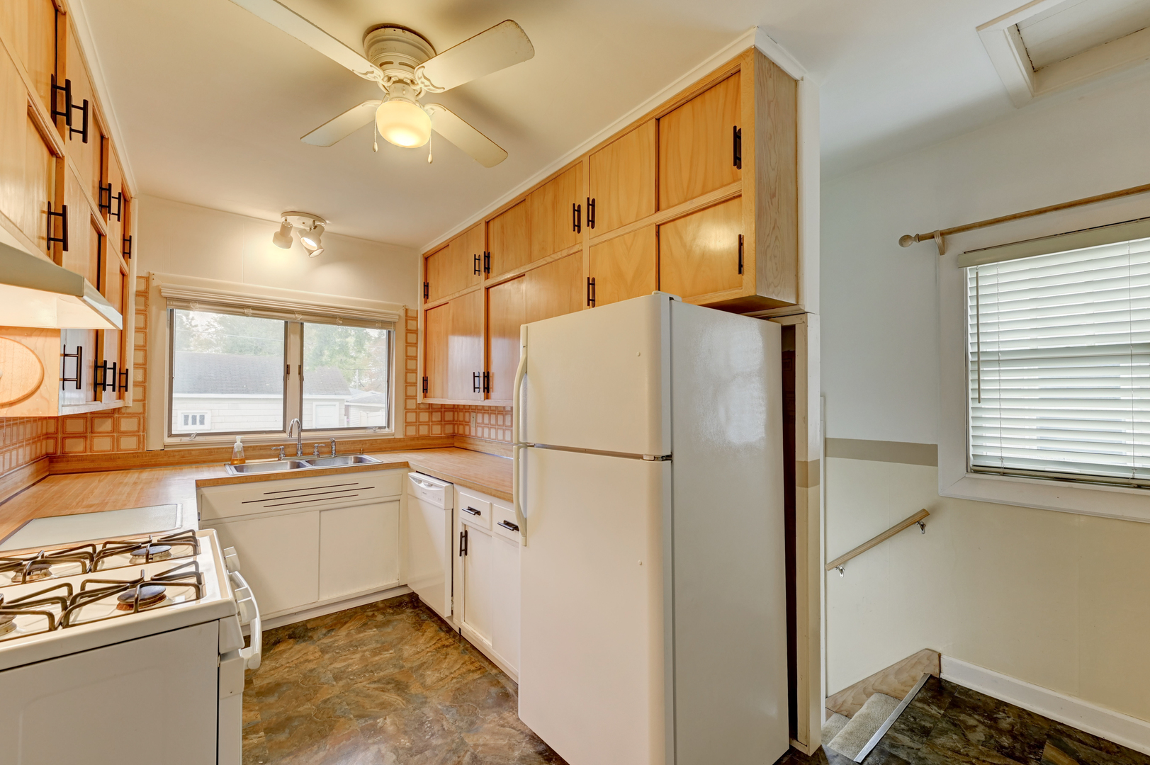 18281 Walter Street Lansing, IL 60438 - Photo 9 of 15 a kitchen with stainless steel appliances granite countertop a refrigerator a sink a stove and white cabinets with wooden floor