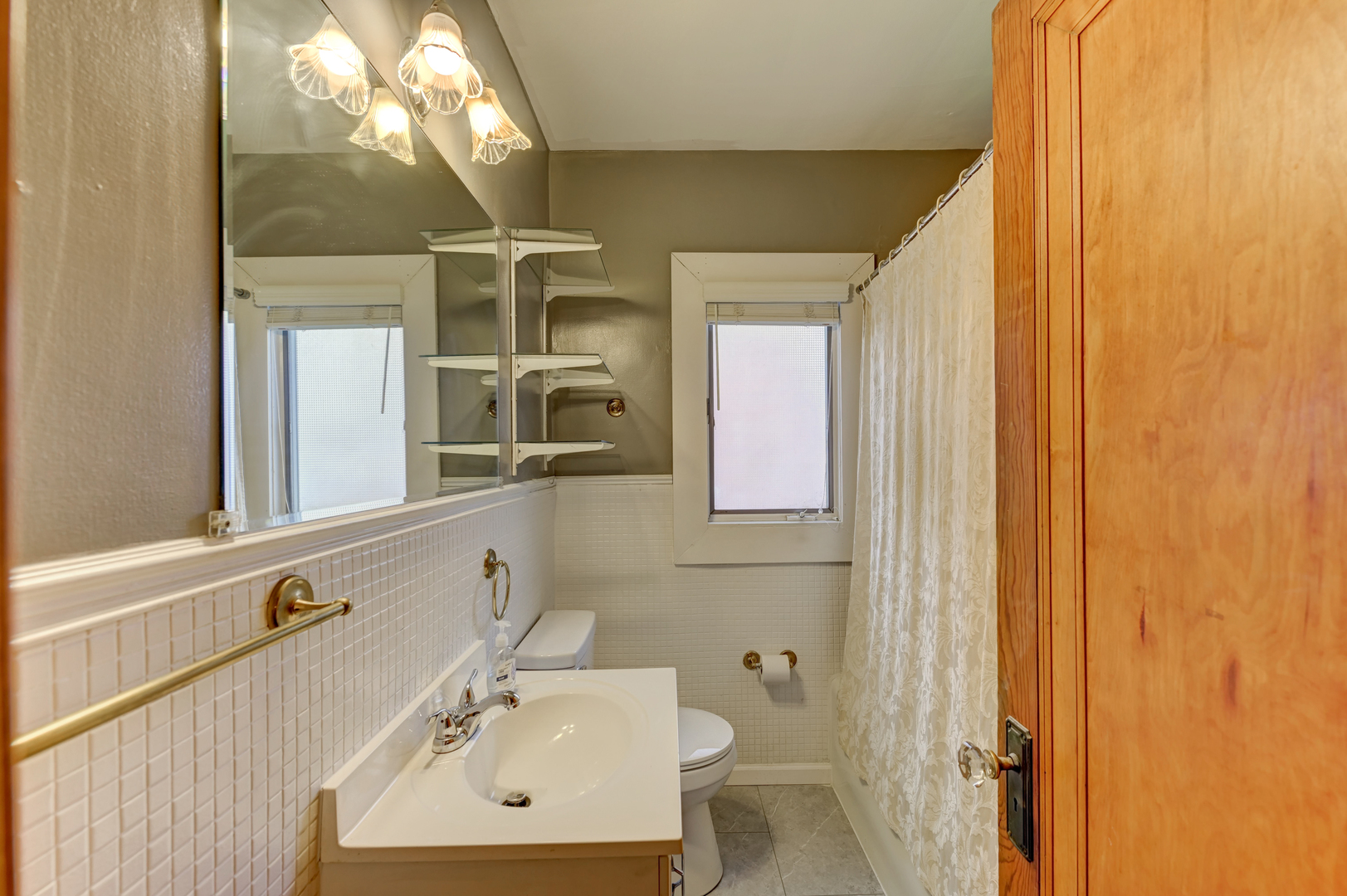 18281 Walter Street Lansing, IL 60438 - Photo 10 of 15 a bathroom with a sink a mirror and a shower