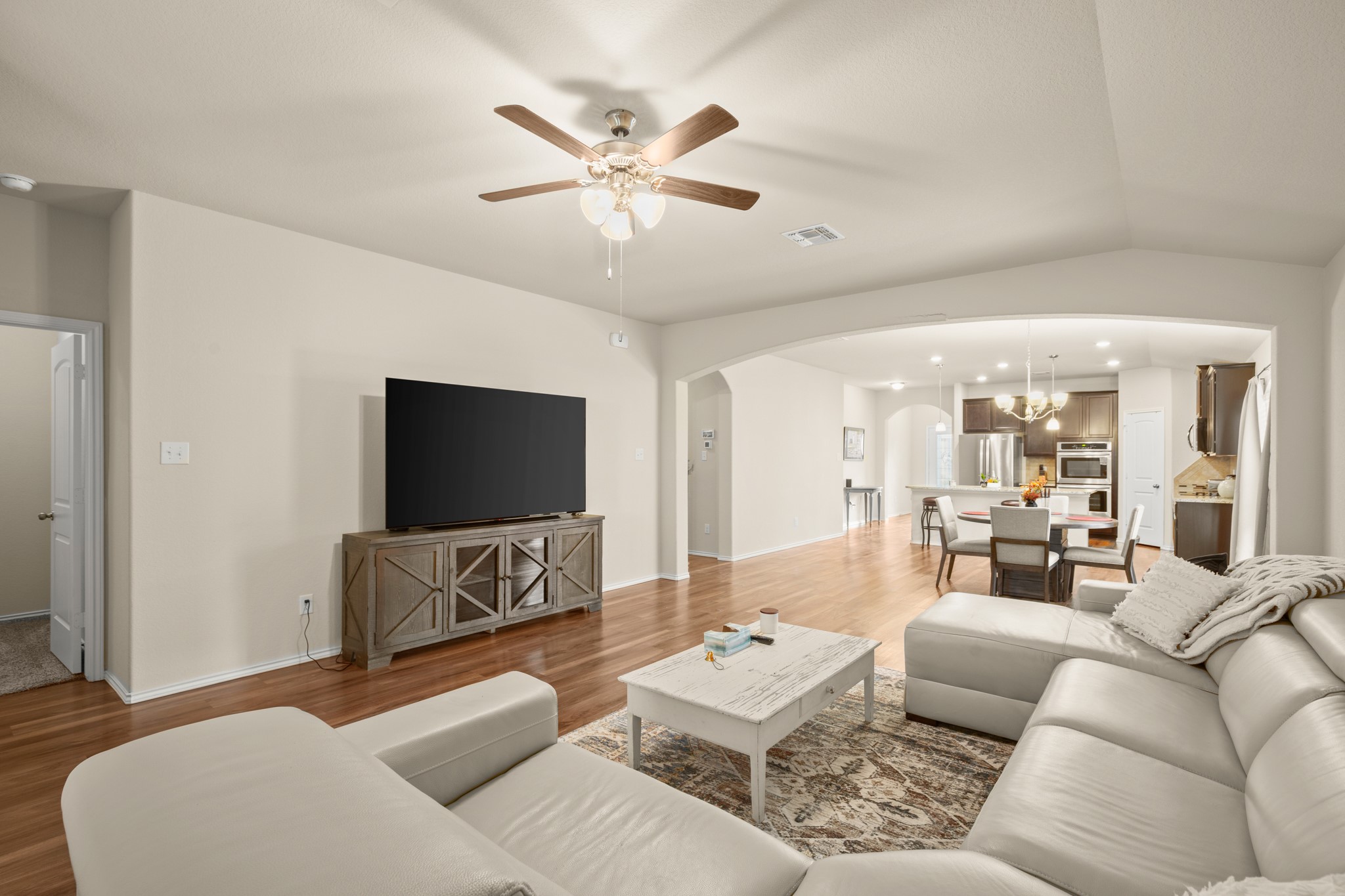 5526 Perdita Drive Belton, TX 76513 - Photo 4 of 26 Living room featuring a ceiling fan, wood finished floors, a chandelier, and lofted ceiling