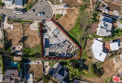 an aerial view of a house with a yard and a fountain