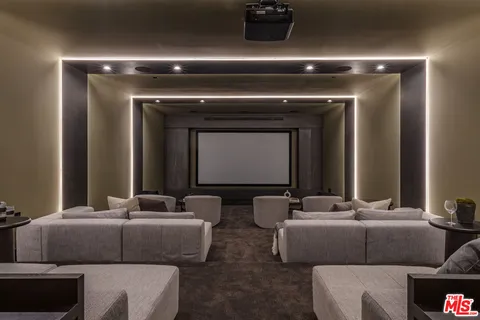 a living room with furniture and a mirror