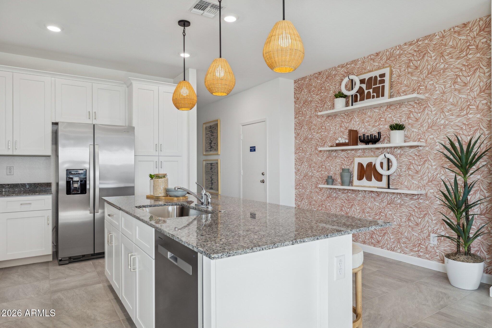 26449 West Crown King Road Buckeye, AZ 85326 - Photo 5 of 33 a kitchen with kitchen island a counter space a sink and refrigerator